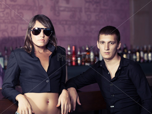 Fashion style photo of a couple in the bar