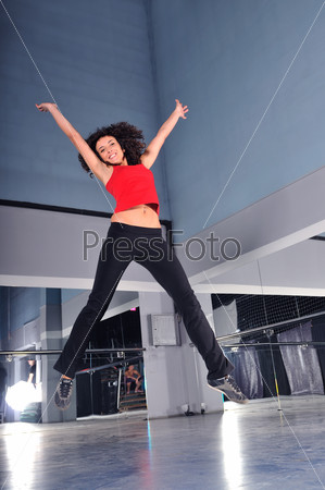 young woman jump in air in fitness studio