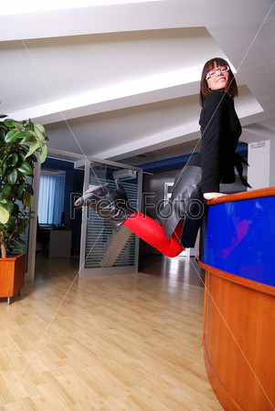 .happy businesswoman jumping in office