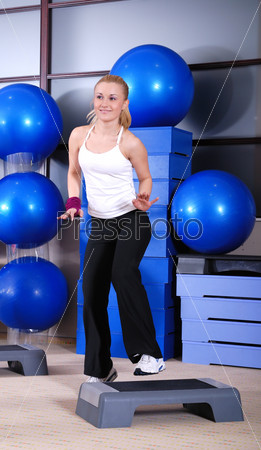 woman stepping in a fitness center