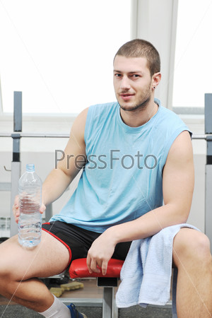 Young man drink water at fitness workout training at sport club, stock photo