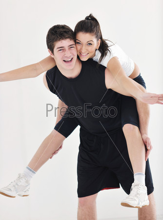 Happy young couple fitness workout and fun at sport gym club, stock photo