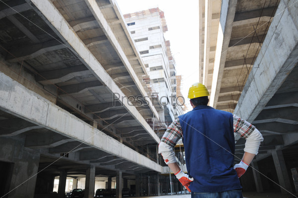 Handsome hard worker people portrait at concstruction site, stock photo