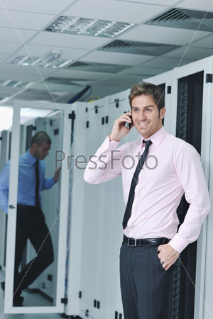 it engineer talking by phone at network room