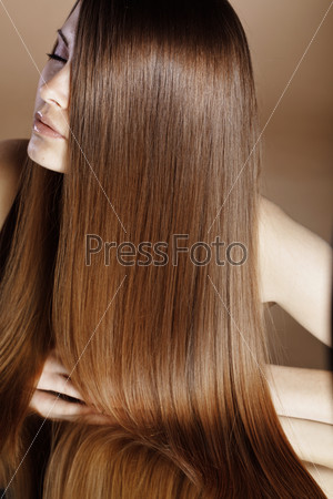 Portrait of young beautiful woman with long glossy hair