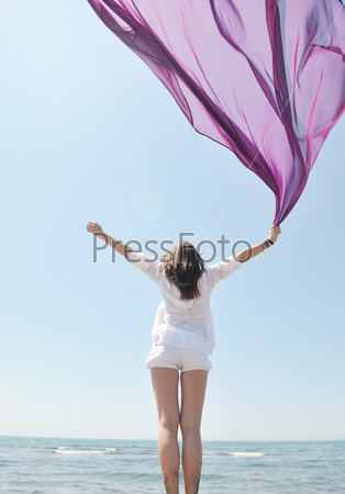beautiful young woman on beach with scarf