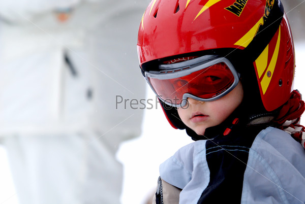 Little skier with helmet and goggles, stock photo