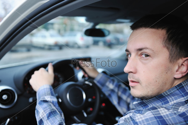 young man using new car navigation and onboard vehicle\
transport system