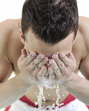 young man washing face with clean water and representing\
hygiene and mans beauty concept