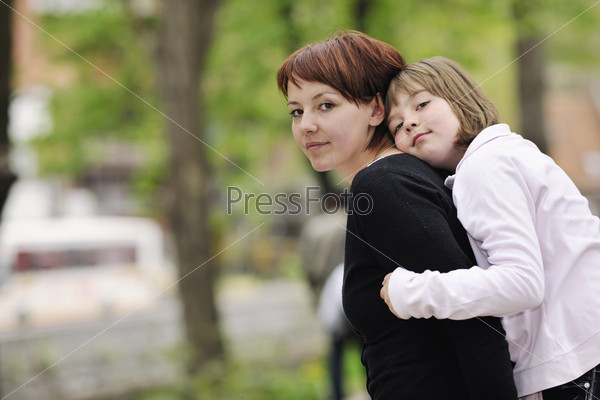 Mother and daughter playing games in nature, stock photo