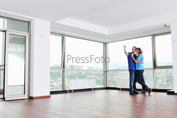 happy young cuple have fun and relax in their new big bright home apartment