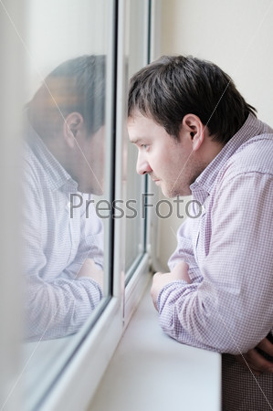 Courageous middle age man looking at the window