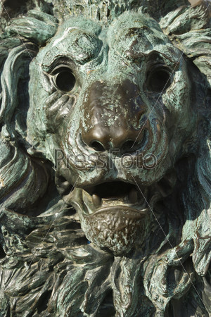 Close-up of bronze lion statue turning green from oxidation in Venice, Italy.