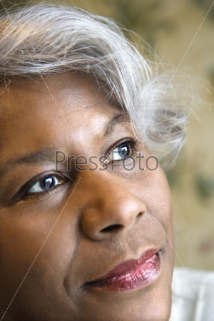Close up portrait of mature African American woman looking to the side.