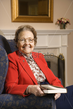 Elderly woman with book.