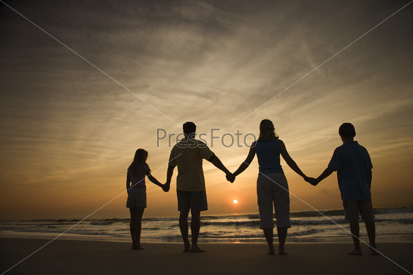 Family Holding Hands on Beach
