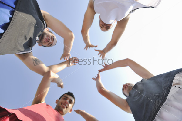 Basketball player team group posing on streetbal court at the city on early morning, stock photo