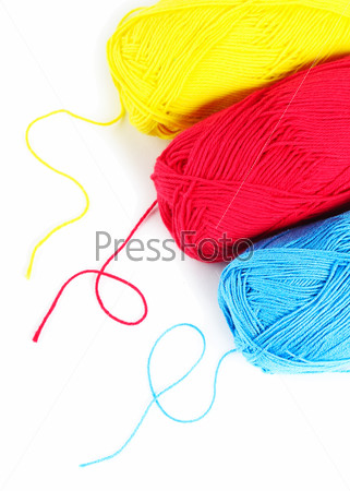 Three clews of woolen yarn over pure white background