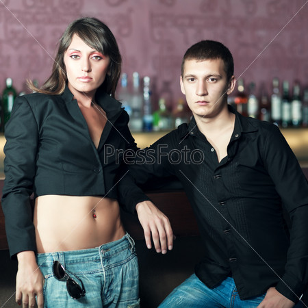 Fashion style photo of a couple in the bar