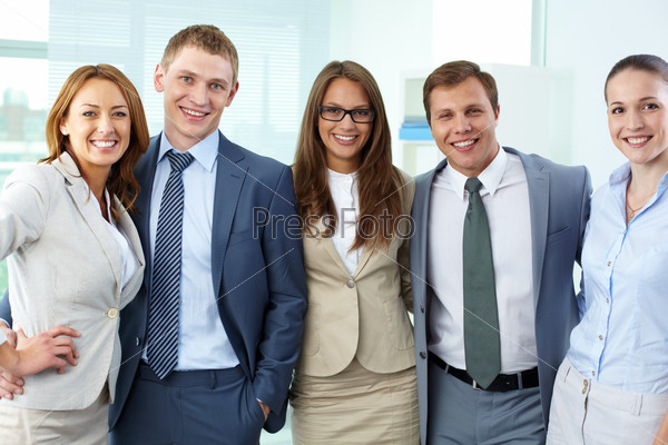 Portrait of five businesspeople in formal clothes looking at camera and smiling
