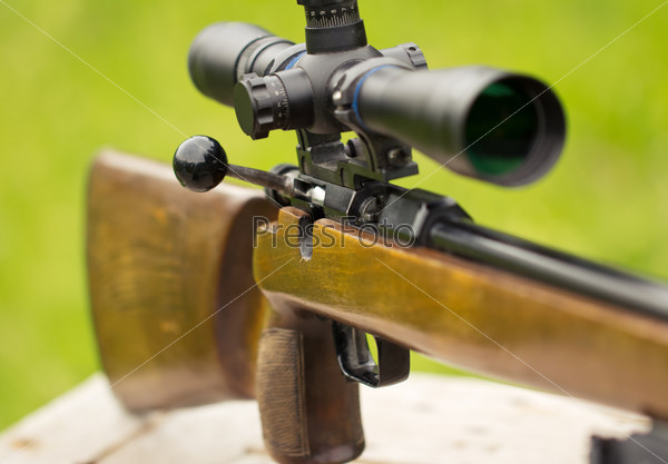 A fragment of a rifle with telescopic sight