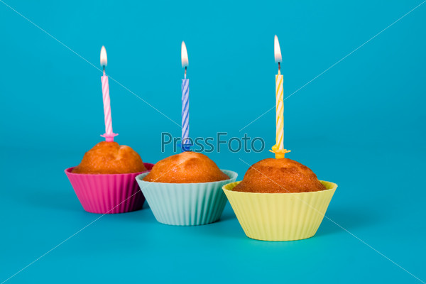 Festive cupcakes with  candles on gradient background
