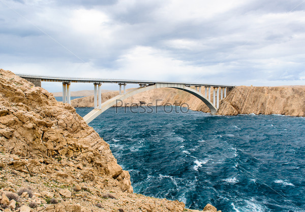 Sky with clouds and stormy waves in the sea, Pag bridge in Croatia