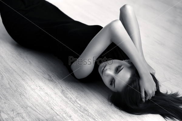 Attractive girl lying on the floor of the wood, stock photo