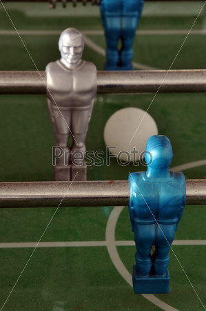 Closeup on foosball table with players, ball and central circle