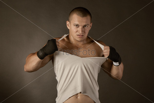 Young Boxer fighter over black, shirt rip to shreds