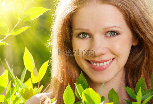 beauty girl in nature with green leaves