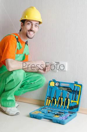 Electrician repairman working in the house