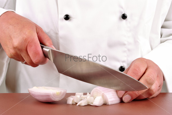 Female chef cut one onion with a kitchen knife