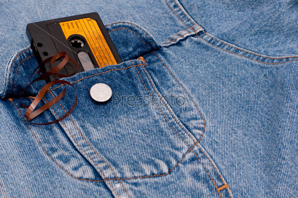 Retro Music - Old Audio Cassette Tape in Pocket of Blue Jeans Jacket