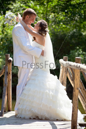 Wedding - happy bride and groom kissing