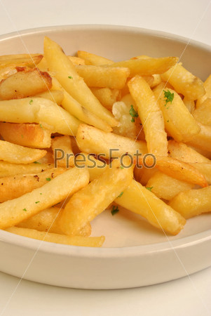 Deep fried chips displayed in a plate, stock photo
