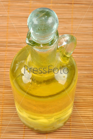 organic olive oil with some garlic in a bottle