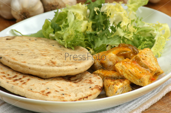 naan bread with turkey curry on a plate