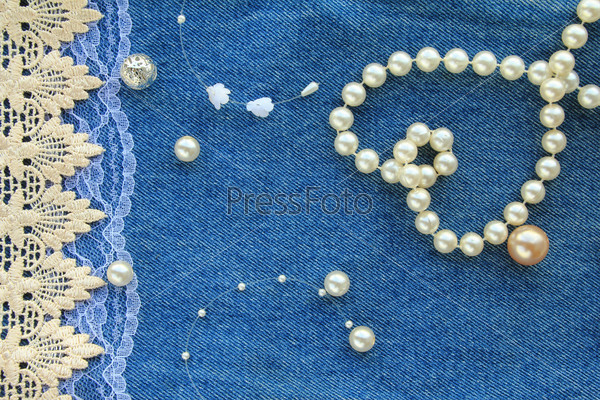 greeting card with a sedets from a beads and laces on a jeans background