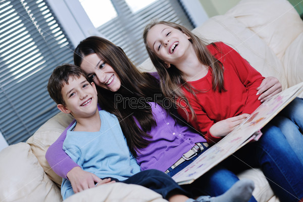 young mom play with their kids at home and reading book