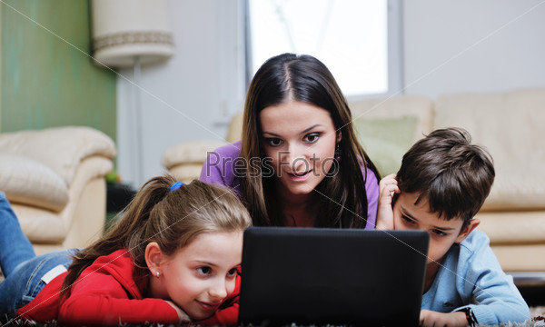 Happy young family with mom and kids have fun and play in modern new living room home indoor, stock photo