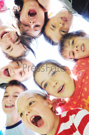 Счастливые дети стоят кругом, соприкасаясь головами