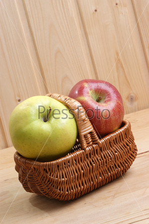 one green and one red apple in a basket