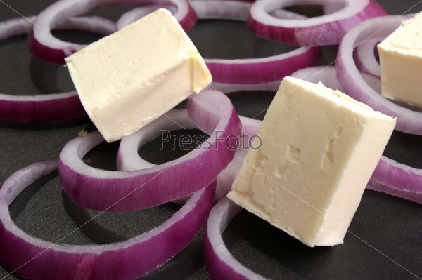 Some onion rings with butter in a pan, stock photo