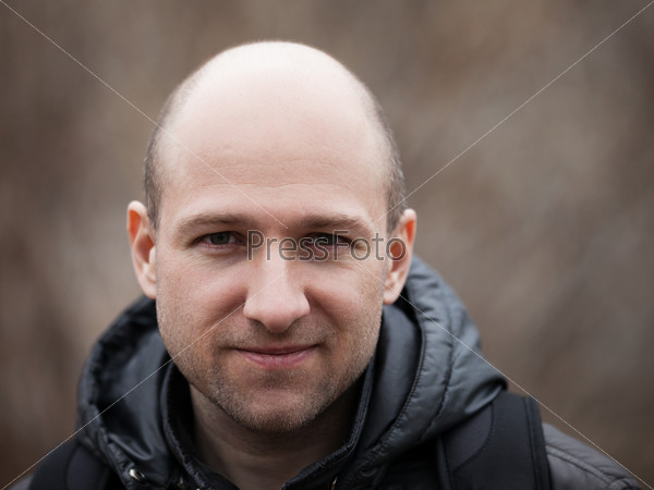 Human alopecia or hair loss - smiling adult man bald head