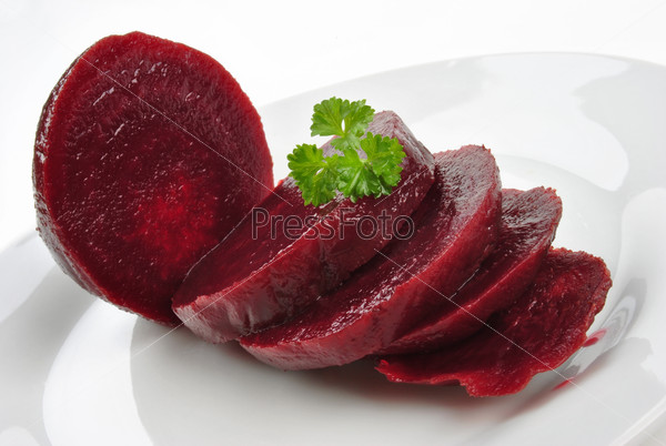 Sliced organic beet root on a white plate, stock photo