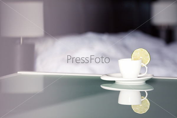 tea with lemon on the background of the bed and the lamp