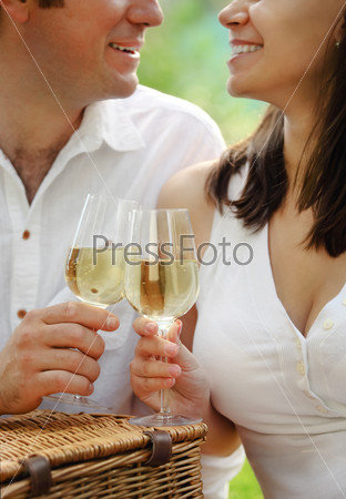 Young happy couple with glasses of white wine