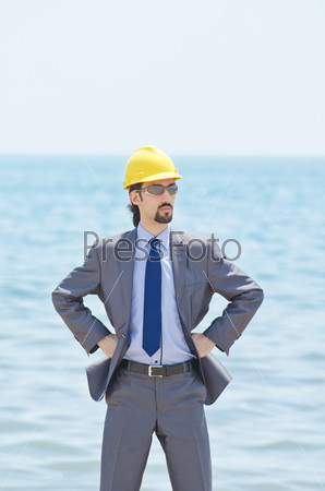 Oil engineer on sea side beach, stock photo