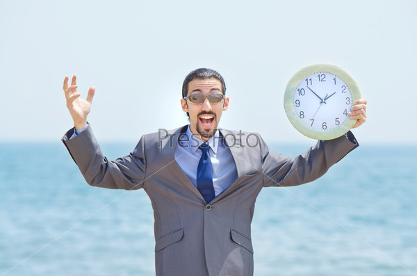 Man with clock on seaside